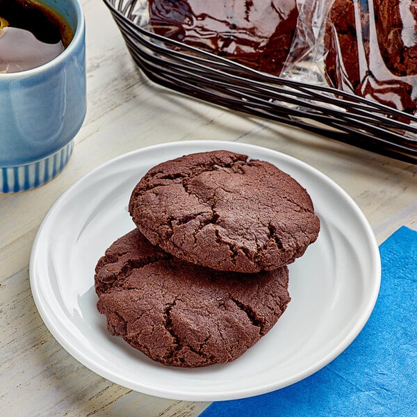 An individually wrapped Southern Roots vegan double chocolate chip cookie on a plate.