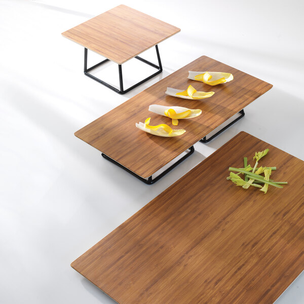 A rectangular faux bamboo melamine serving board with endive leaves on it.