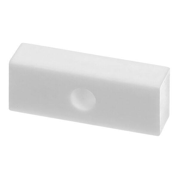A white rectangular object with a hole in the middle.