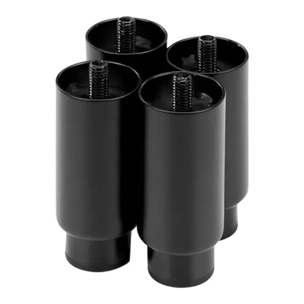 A close-up of four black plastic cylinders with screws on top.