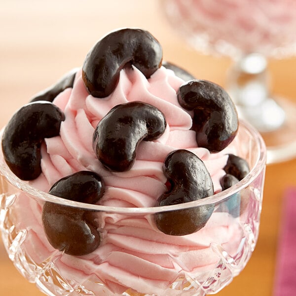 Dark chocolate covered cashews in a close-up photo.