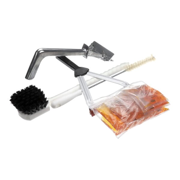 A Garland grill cleaning kit including a brush and tongs.