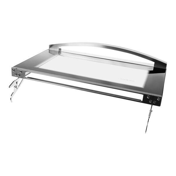 A silver tray with a clear glass top on a rectangular silver object with black hinges.