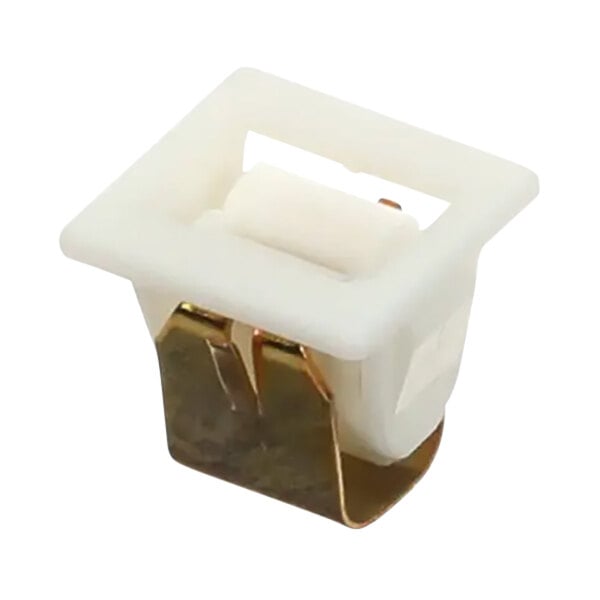 A white plastic square with a gold metal latch.