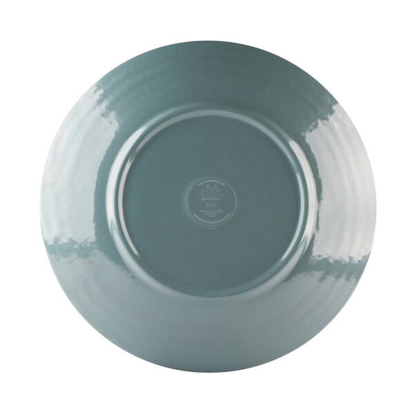 An Elite Global Solutions round melamine plate with a white background and blue rim.