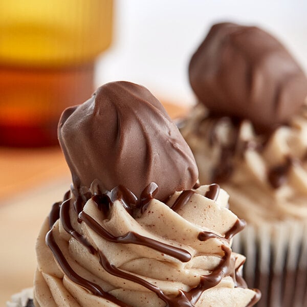 A chocolate covered peanut butter meltaway on a counter.