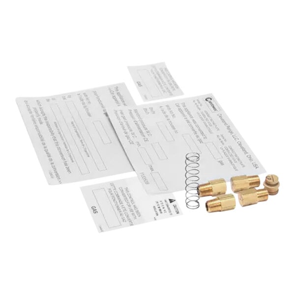 A few brass fittings and papers for a Garland / US Range LP conversion kit.