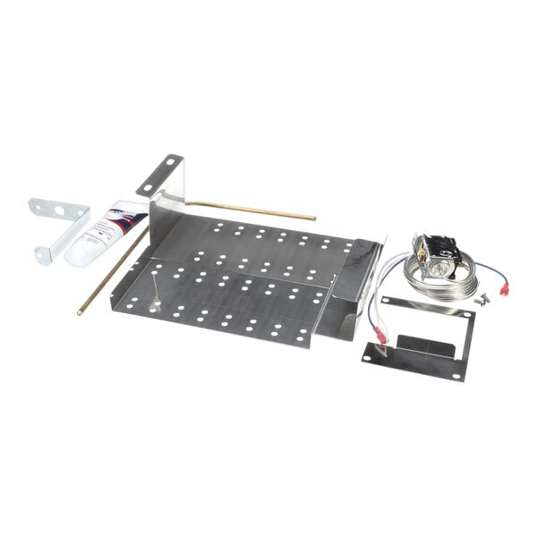 An Ice-O-Matic metal frame and plate with a tube and wires.