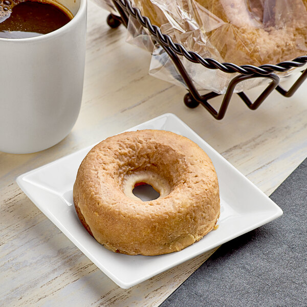 A Southern Roots individually wrapped pumpkin spice cake donut on a plate.