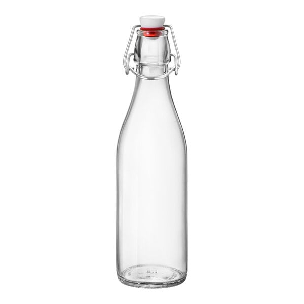 A clear glass bottle with a red stopper.