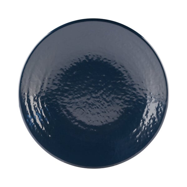 A close-up of an Elite Global Solutions Pebble Creek Lapis-colored plate with a white center and a blue ripple effect around the rim.