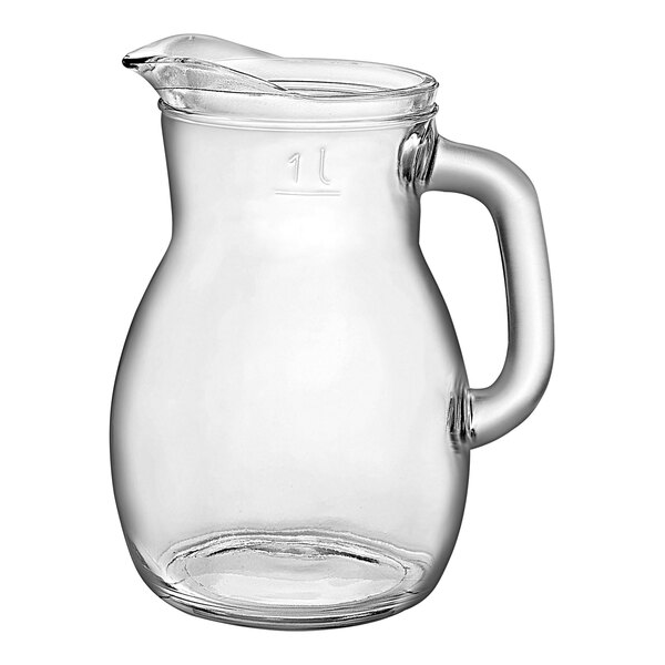 A clear glass pitcher with a handle.