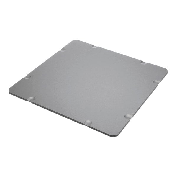 A grey square metal plate with a hole in the middle.