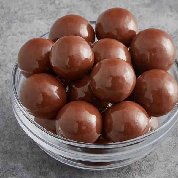 A bowl of Albanese milk chocolate malt balls.