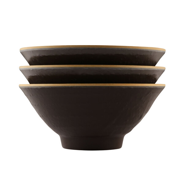 Three black Elite Global Solutions Pebble Creek Tapenade bowls with gold trim stacked on a white surface.