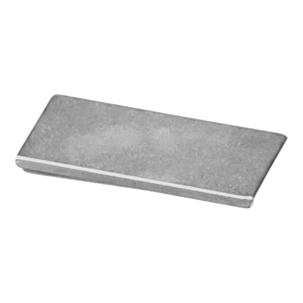 A Cretors rectangular metal magnet with adhesive backing.