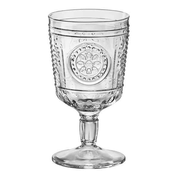 A close-up of a clear Bormioli Rocco wine goblet with a design on it.