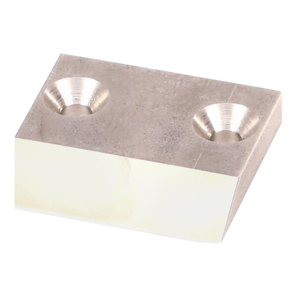A white metal Garland / US Range wear pad with two holes in it.