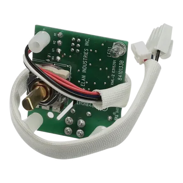 A green circuit board with white wires and a white strap.