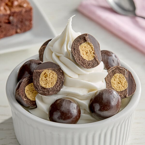 A bowl of ice cream with Albanese dark chocolate malt balls.