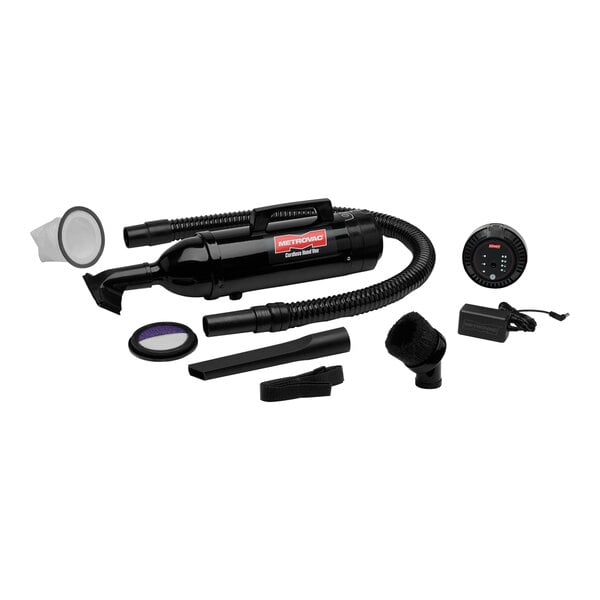 A black MetroVac handheld canister vacuum with filter and accessories.