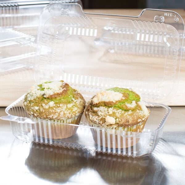 A Dart clear plastic container holding two muffins.