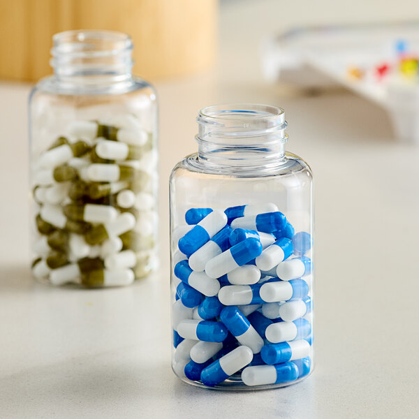 A clear PET packer bottle filled with pills.