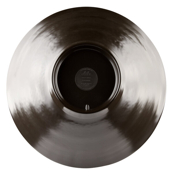 A mushroom-colored melamine bowl with a circular center and a black rim.