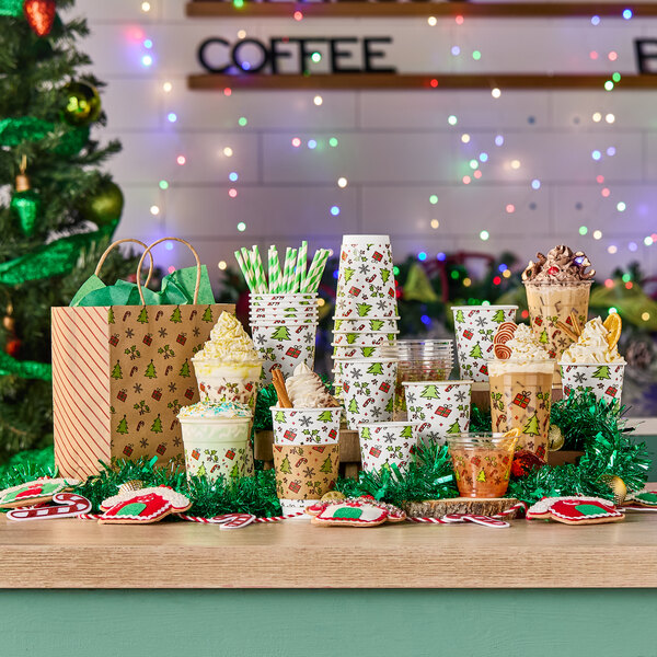 A stack of clear plastic cold cups with holiday-themed designs, displayed among other festive party supplies.