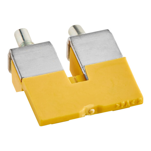 A yellow and silver rectangular Noble Warewashing 2-way bridge terminal.