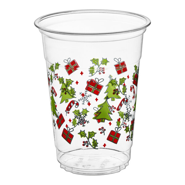 A clear plastic cup decorated with Christmas-themed images such as trees, presents, holly, candy canes, and snowflakes.