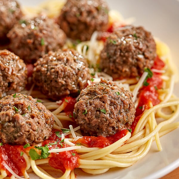 A plate of spaghetti and PAOW! plant-based meatballs with sauce.