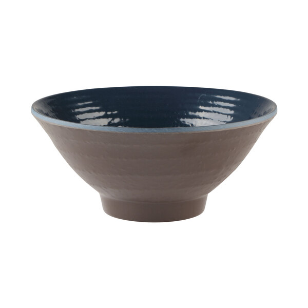 A close-up of an Elite Global Solutions Pebble Creek Lapis-colored bowl with a dark blue and grey design and a blue rim.