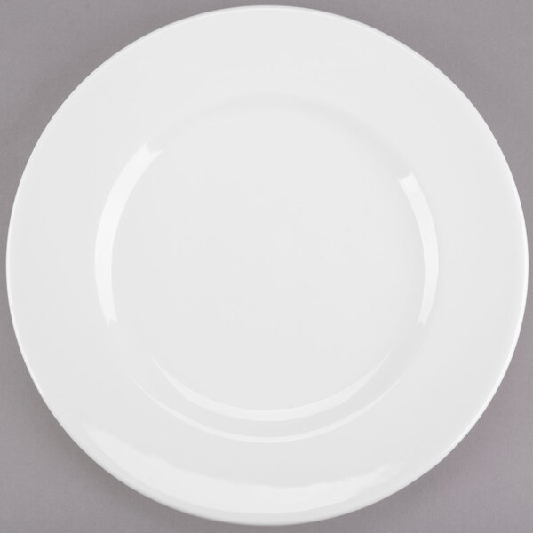 A Libbey white porcelain plate with a wide rim on a gray surface.