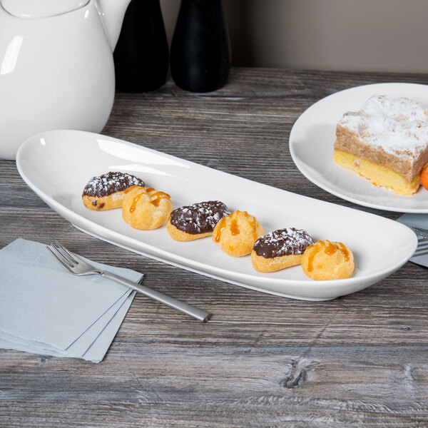 A piece of cake with a white layer on top on a Libbey oval porcelain plate.