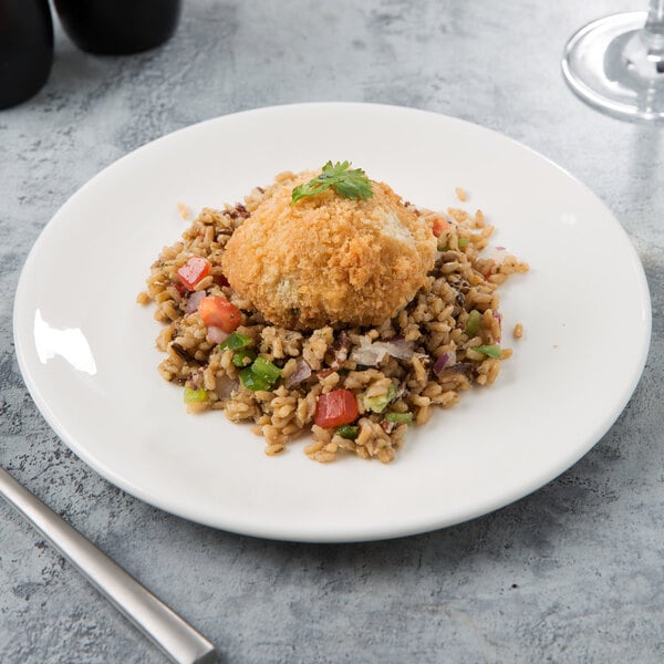 A Libbey white porcelain coupe plate with a fried egg and rice on it.