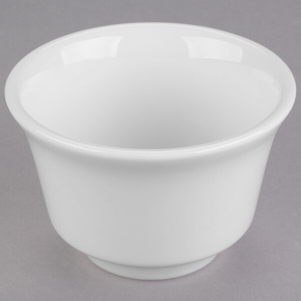 A Libbey white porcelain bouillon bowl with a lid on a gray surface.