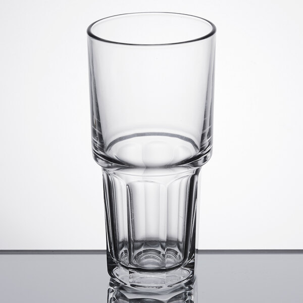 A close-up of a Libbey Gibraltar stackable cooler glass on a reflective surface.