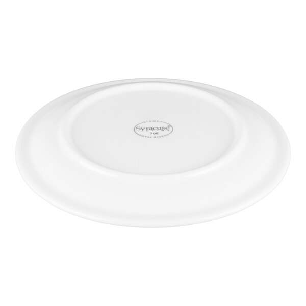A white, round porcelain plate shown upside down with a visible maker's mark in the center.