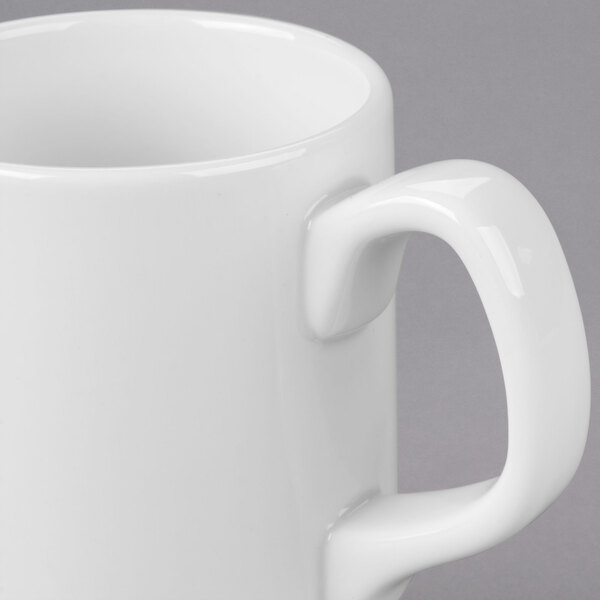 A close-up of a Libbey Royal Rideau white porcelain mug with a handle.