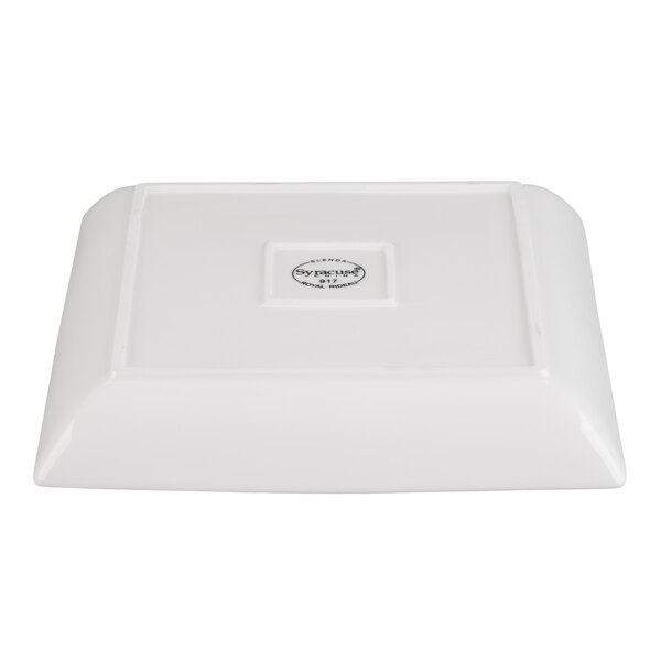 A white square porcelain coupe plate shown upside down.