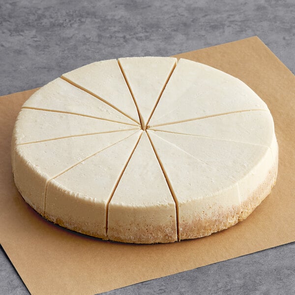 Sirabella's Pre-Cut 12-Slice Vegan Cheesecake on a paper with six slices cut out.