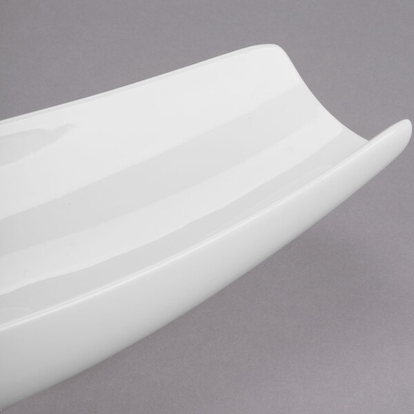 A white Libbey canoe plate with a curved edge.
