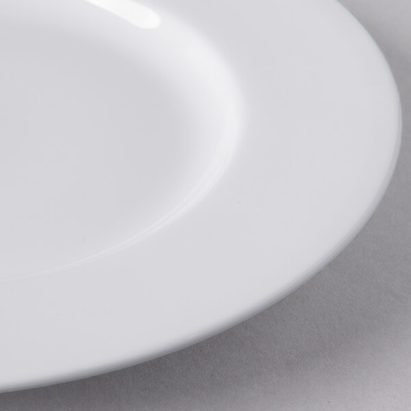 A close up of a Libbey white porcelain plate with a wide white rim.