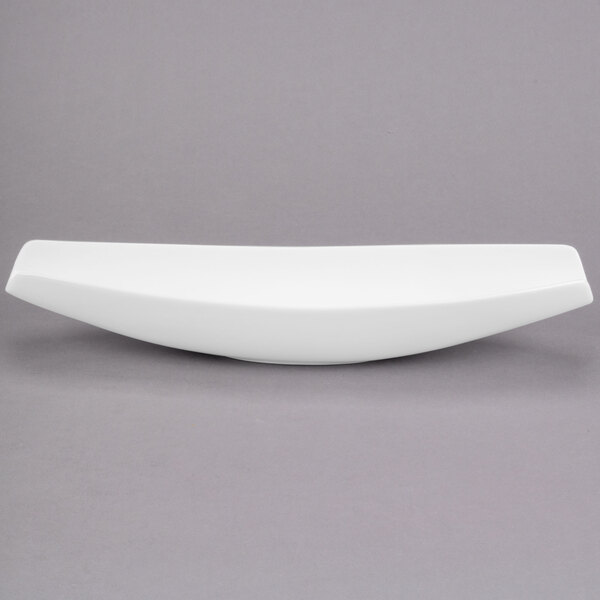 A white Libbey porcelain canoe plate with a curved edge.