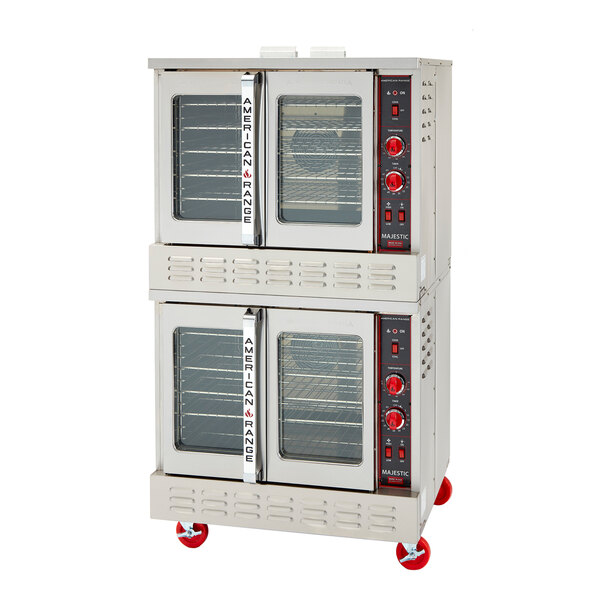 A double-deck commercial convection oven with glass doors and red control knobs, mounted on red caster wheels.