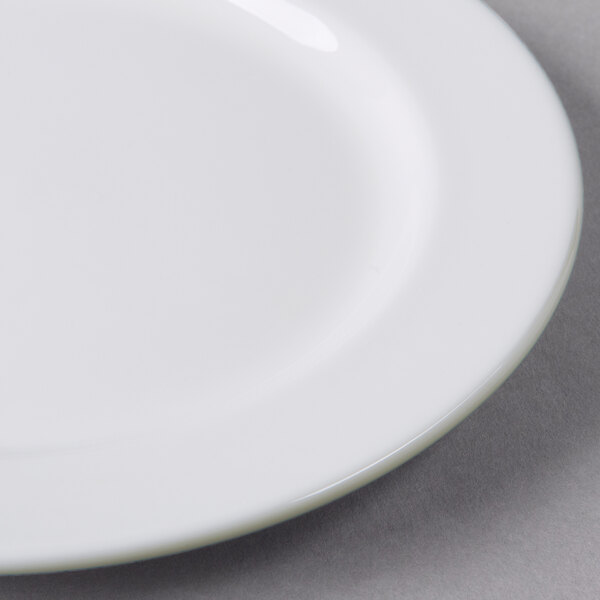 A Libbey white porcelain plate with a medium rim on a gray surface.