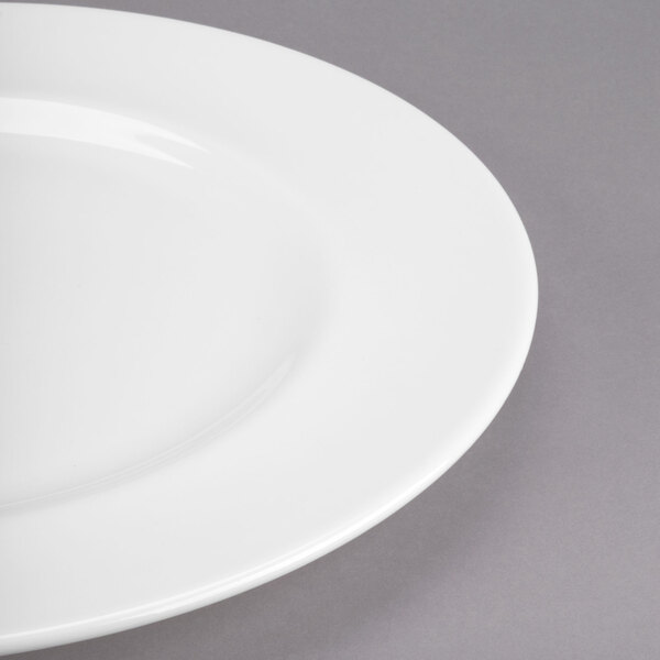 A close-up of a Libbey white porcelain plate with a wide rim.