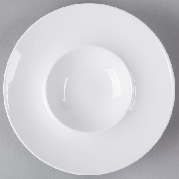 A white plate with a small bowl on top.
