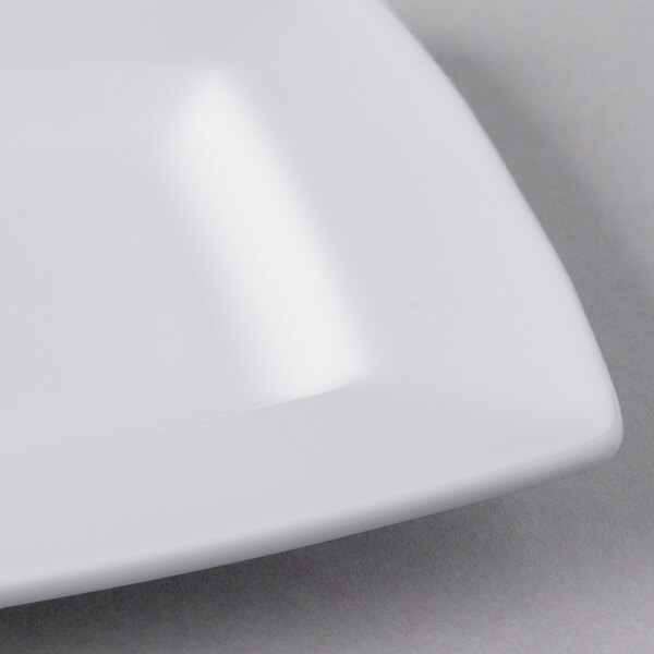 A close-up of a Libbey rectangular white porcelain plate with a square edge.